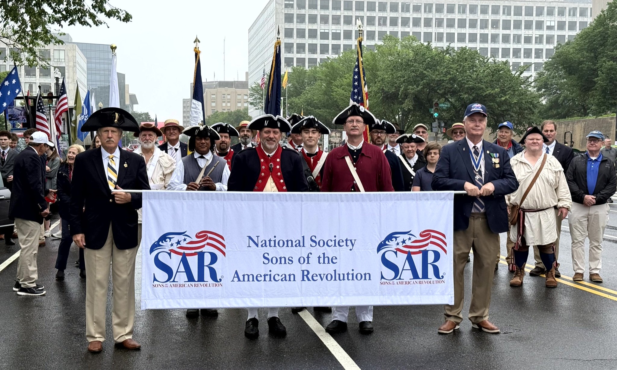 SAR compatriots stand behind National Society banner for the 2026 National Memorial Day Parade